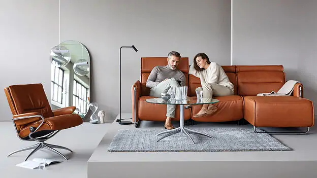 older couple sitting on leather sofa