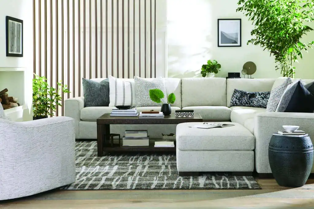 white sectional and swivel seat around the coffee table in a decorated living area