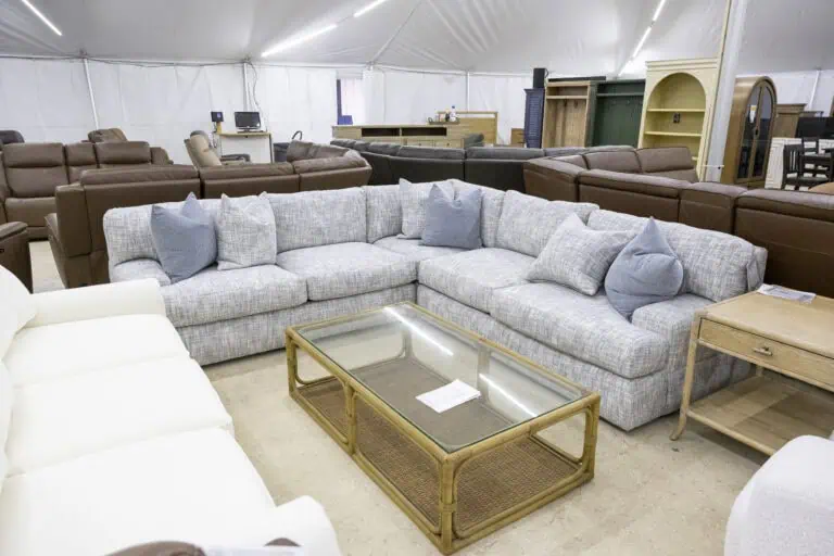 Grey Bernhardt three piece sectional with glass top coffee table