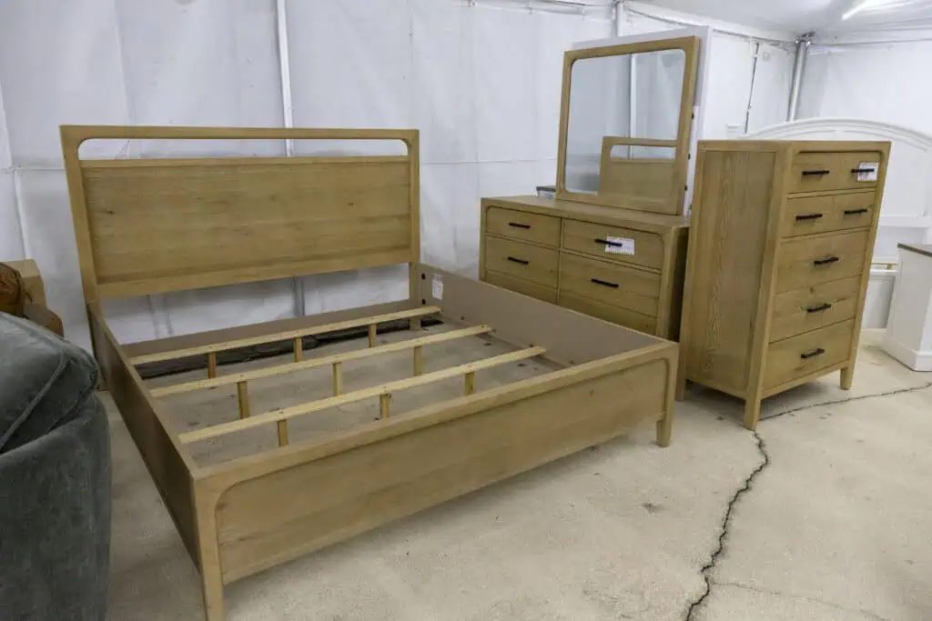 wooden bedroom set with bed frame, tall dresser, and dresser with mirror