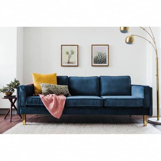 Blue Velvet couch in living room gold lamp