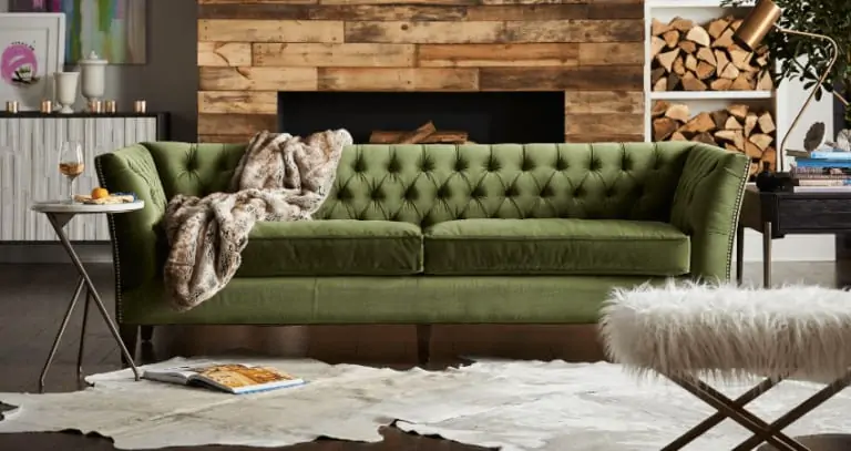 green velvet sofa fireplace cow rug