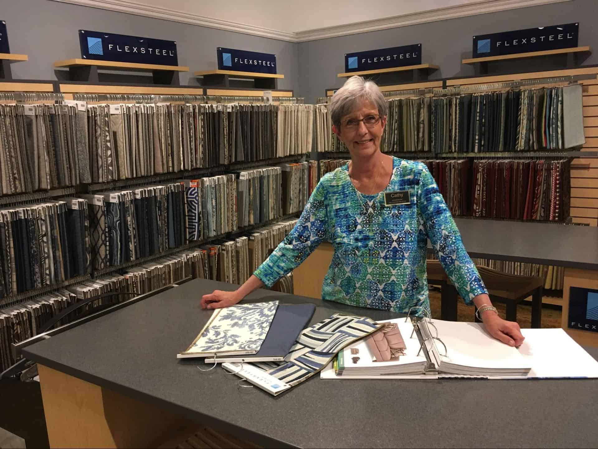 A woman stands in front of the Flexsteel design section at Woodchuck's Furniture showroom