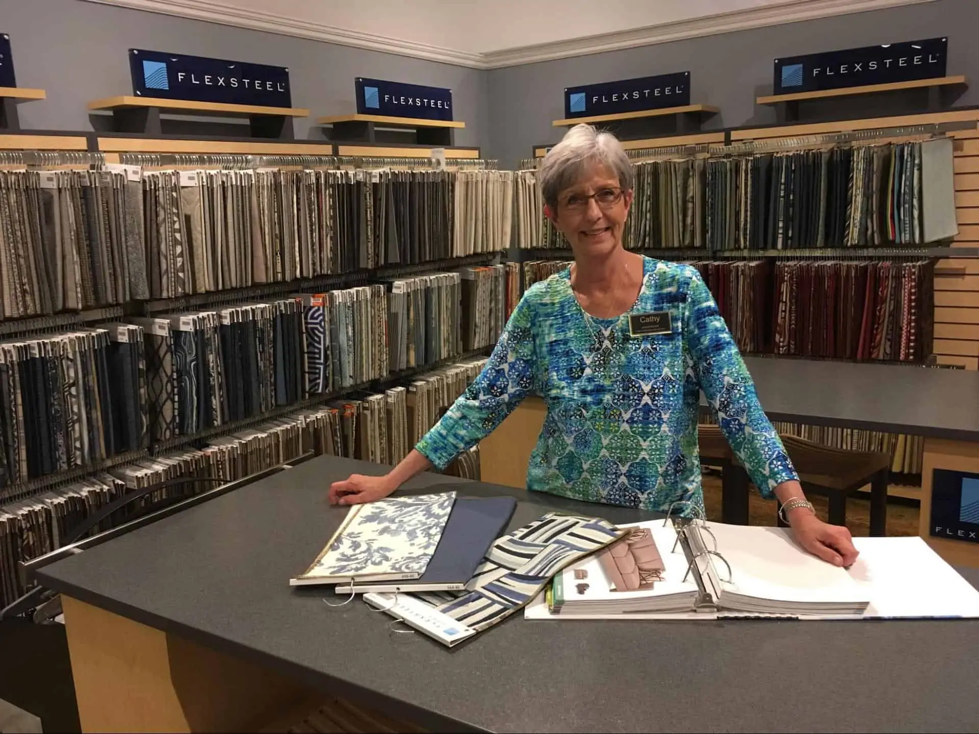 A woman stands in front of the Flexsteel design section at Woodchuck's Furniture showroom