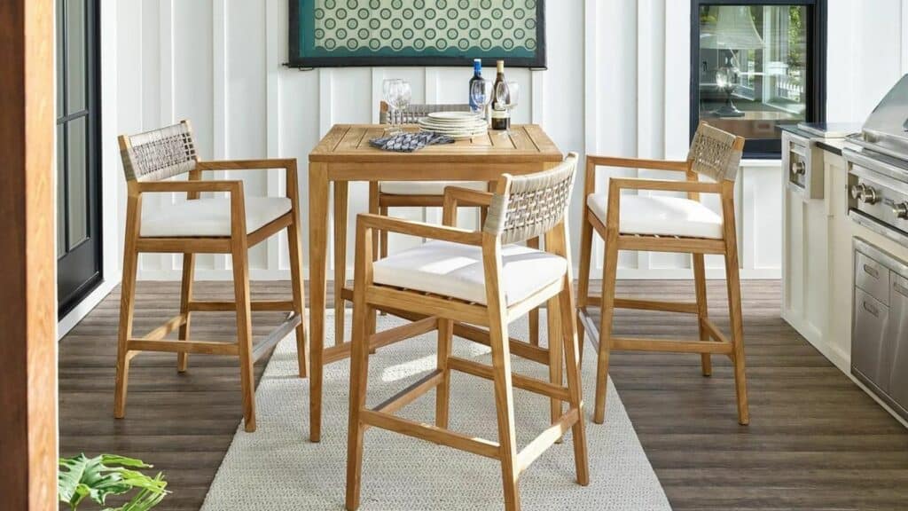 A hightop outdoor table and four tall stools