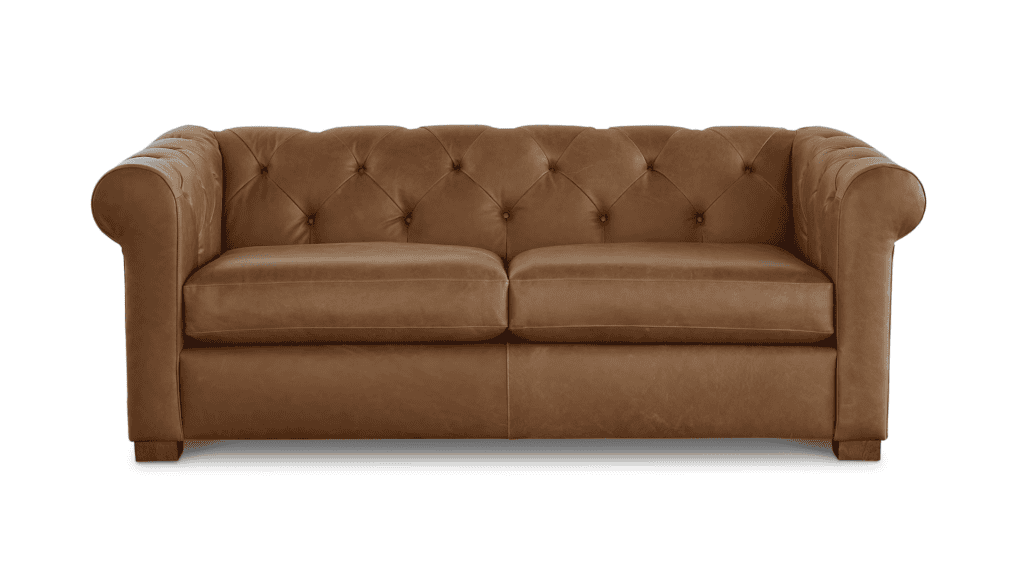 Cognac colored leather loveseat with pleated detailing