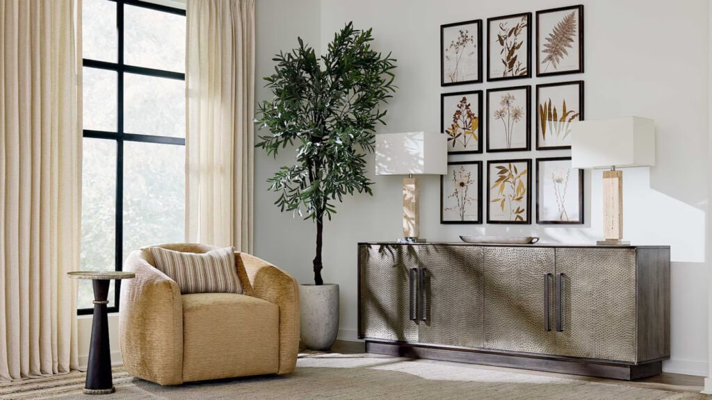 A scene of a decorative room with an arm chair and a side table