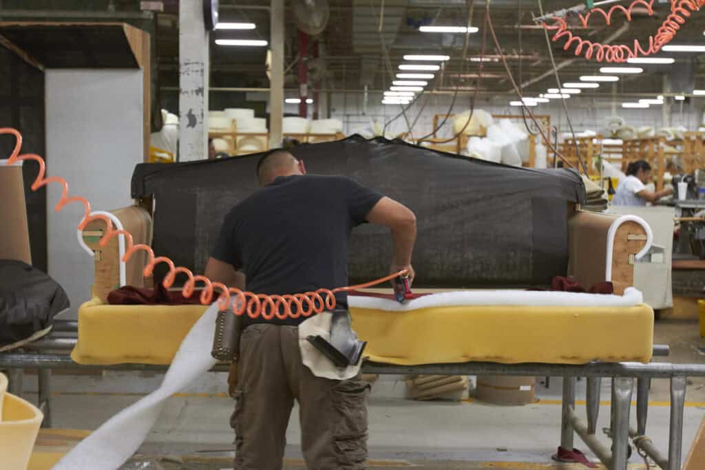 man upholstering a couch