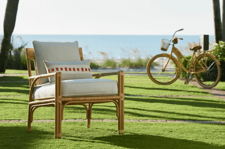 rattan chair and yellow bicycle on grass overlooking ocean