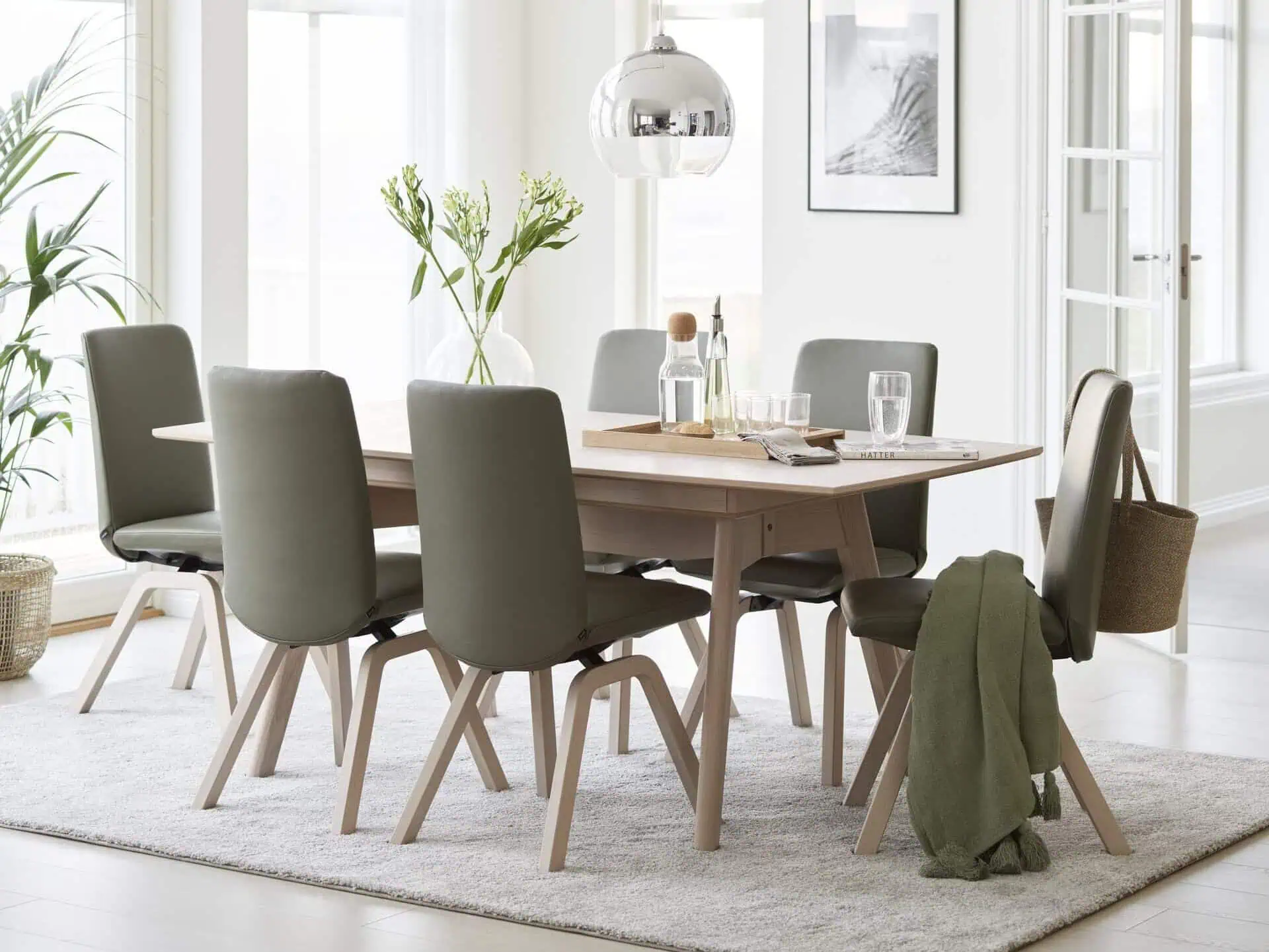 six stressless dining room seats around a dining table with decor