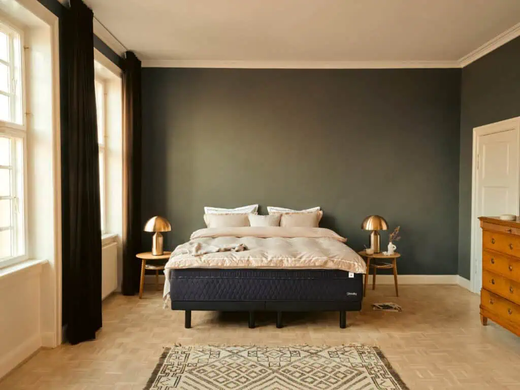 stressless sky mattress in a bedroom with green walls, 2 bedside tables and a carpet