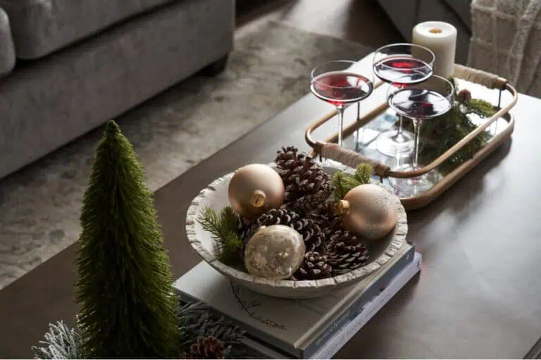 christmas themed table with decor in a bowl and holiday inspired cocktails