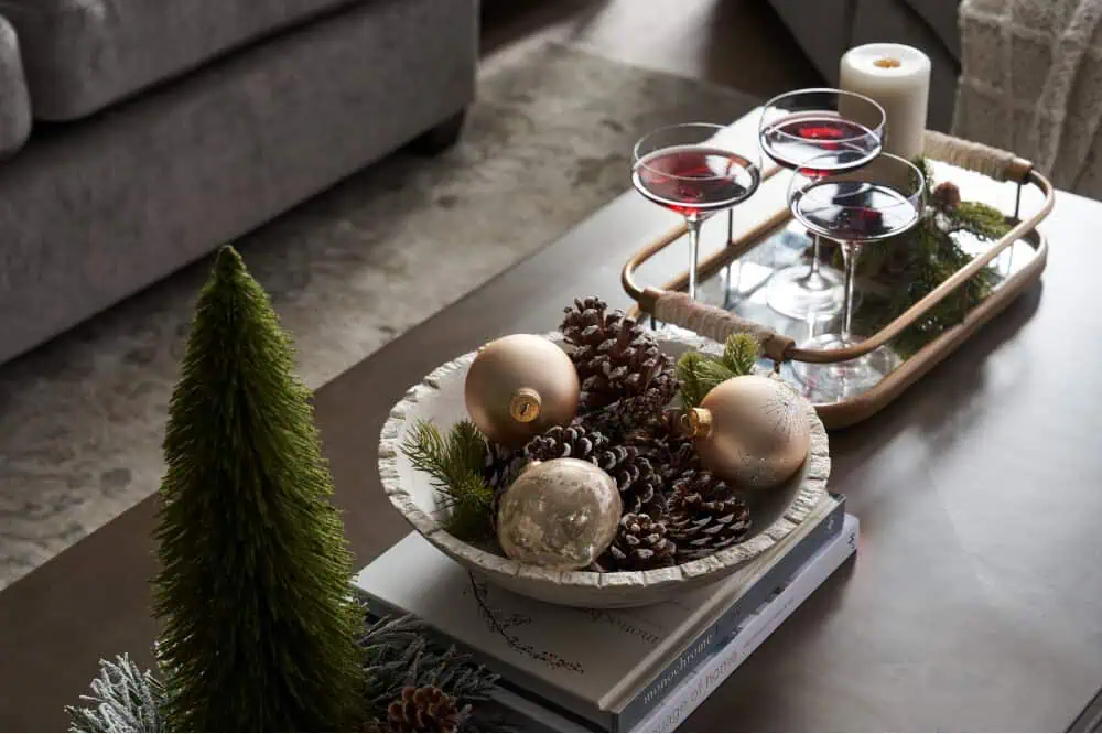 christmas themed table with decor in a bowl and holiday inspired cocktails