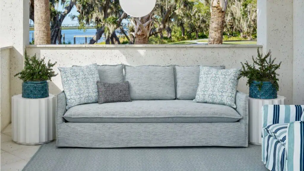 Universal outdoor blue fabric sofa on an outdoor rug with two side tables