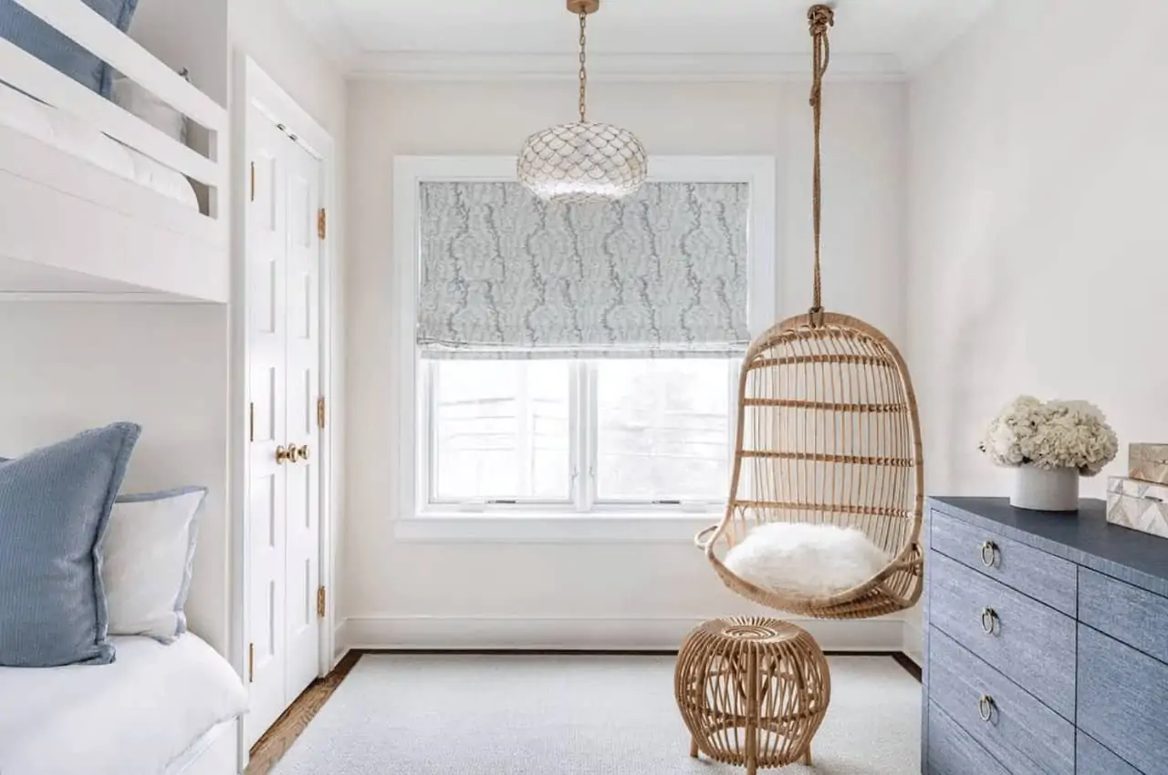 a hanging chair in a guest bedroom