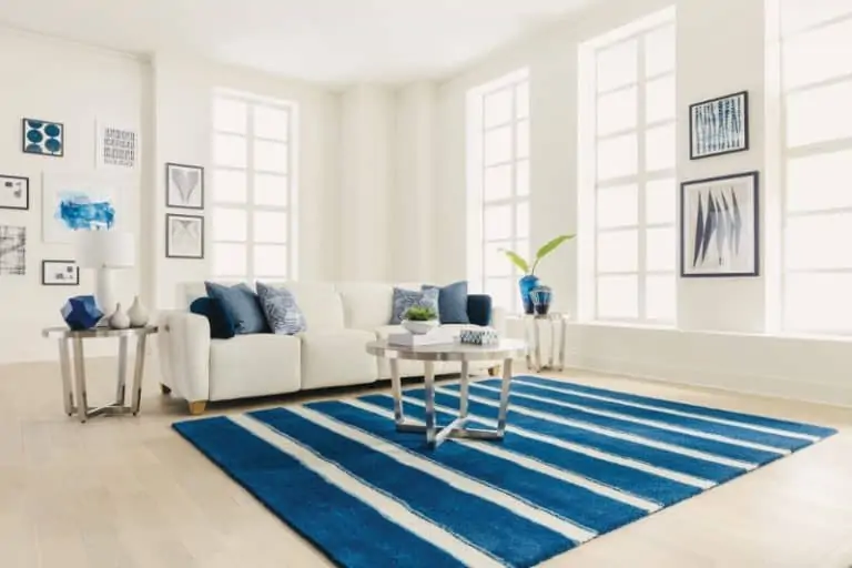 large room white sofa bright blue striped rug