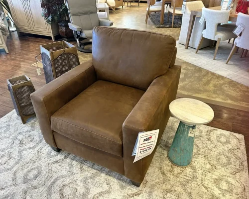 A stylish brown leather chair showcased in a furniture store.