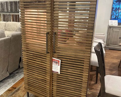 Stylish wooden slatted storage cabinet ideal for modern interiors, featuring a double-door design with sleek handles, perfect for organizing your space.