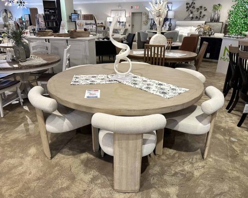 A round wooden table with four chairs in Woodchuck's showroom