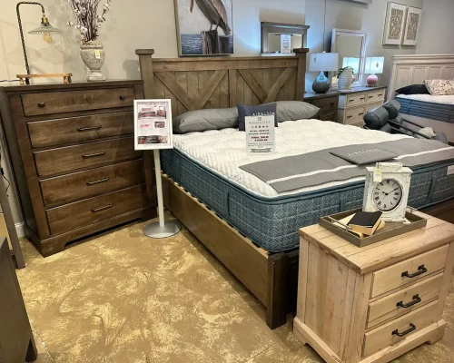 A cozy bedroom featuring a neatly made bed, a dresser, and a nightstand beside it.