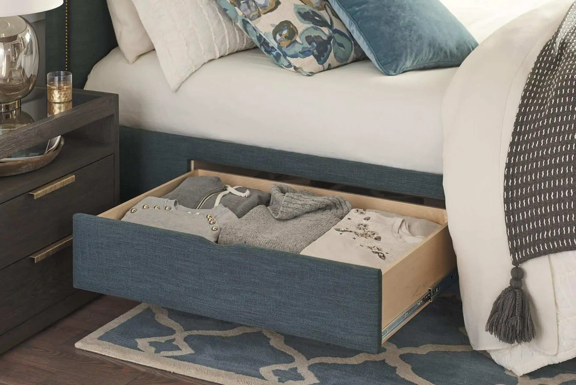 Bed with drawer that pulls out, holding sweaters