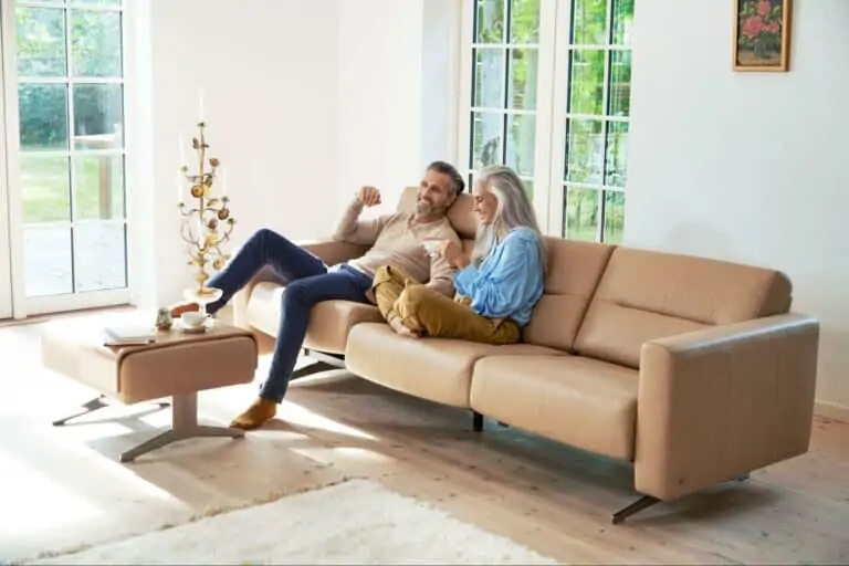 A man and woman sit on a couch