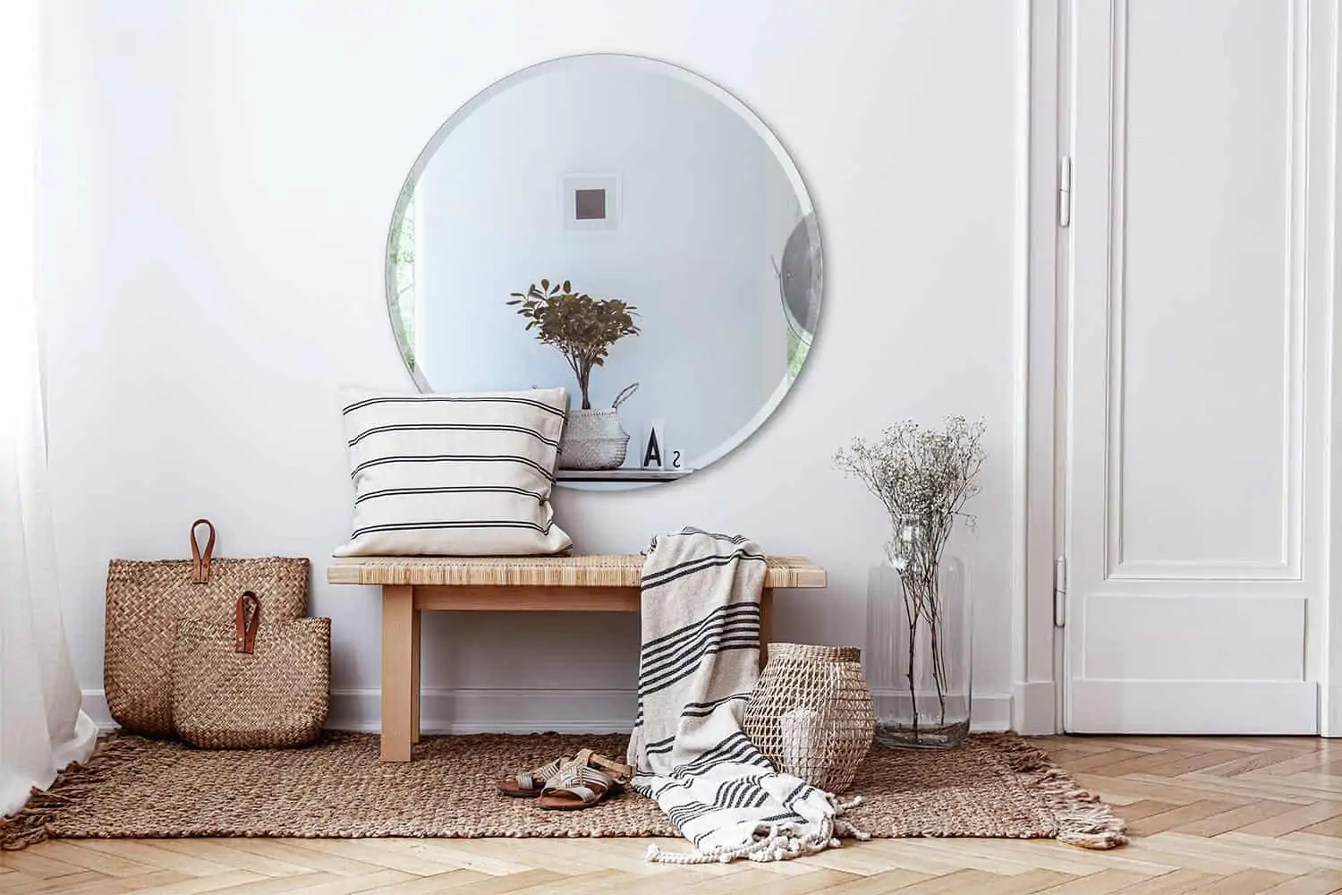 entryway in house with round mirror on wall and bench underneath