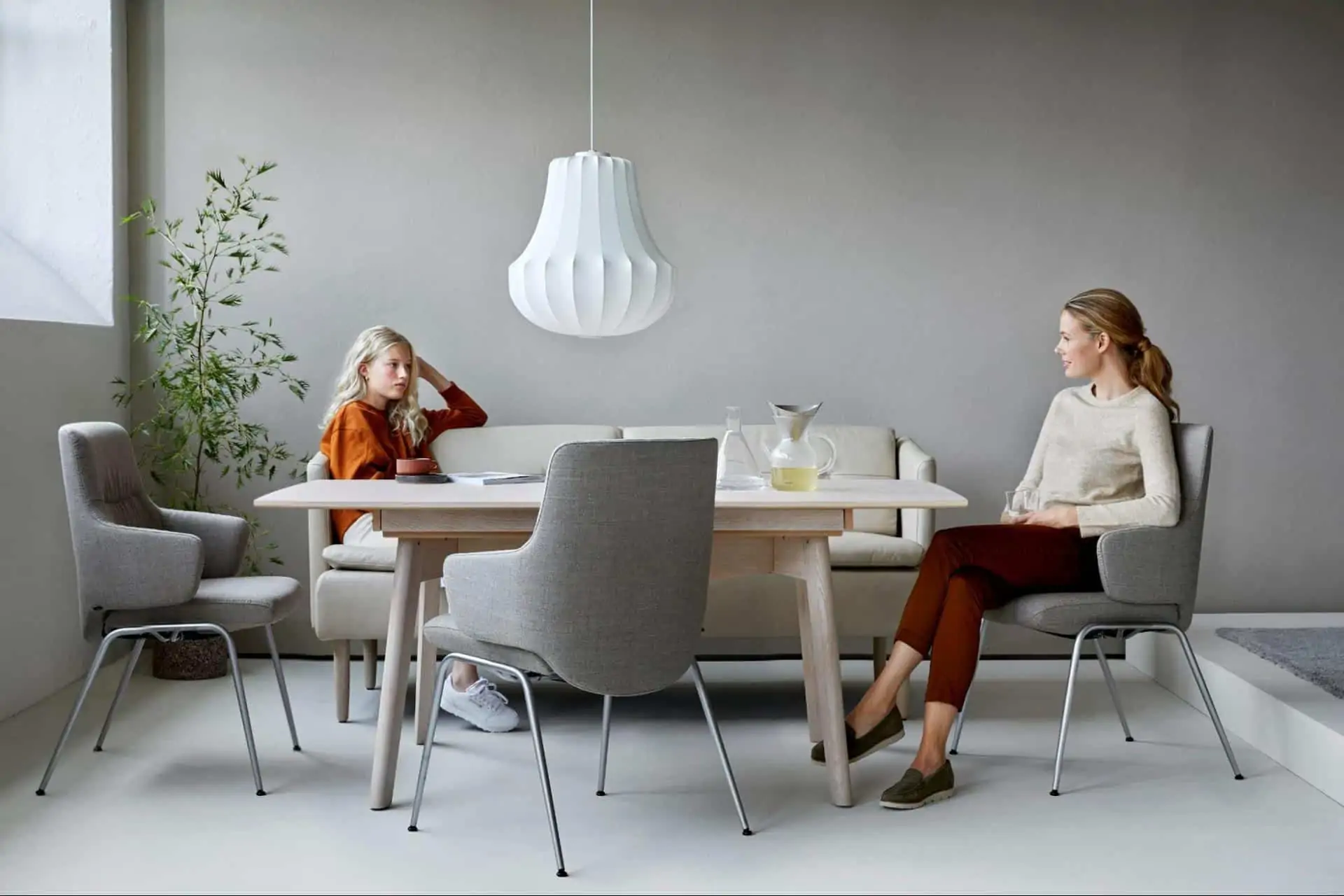 two women sit at a Stressless dining room table