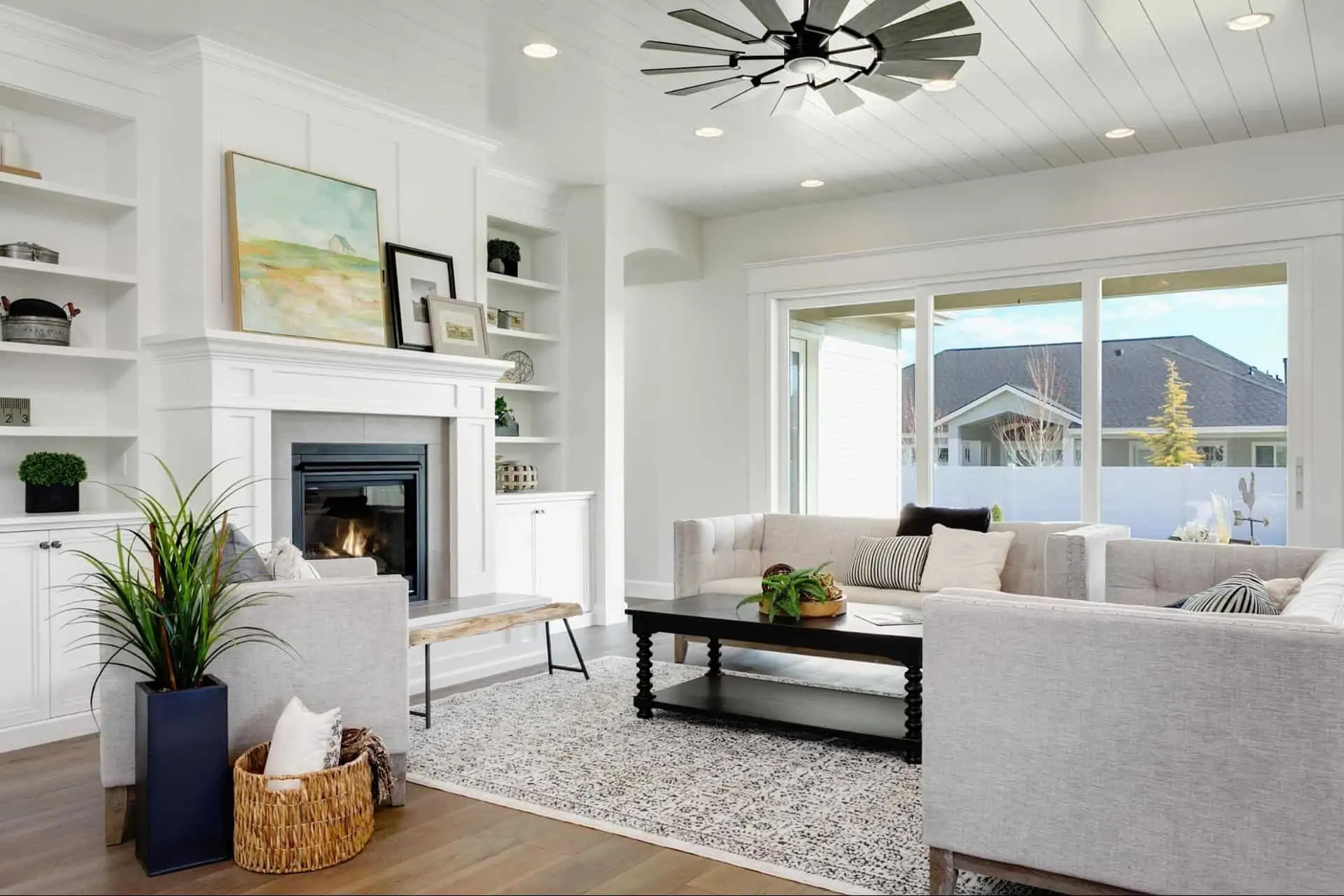 living room with white walls and white furniture. big open windows