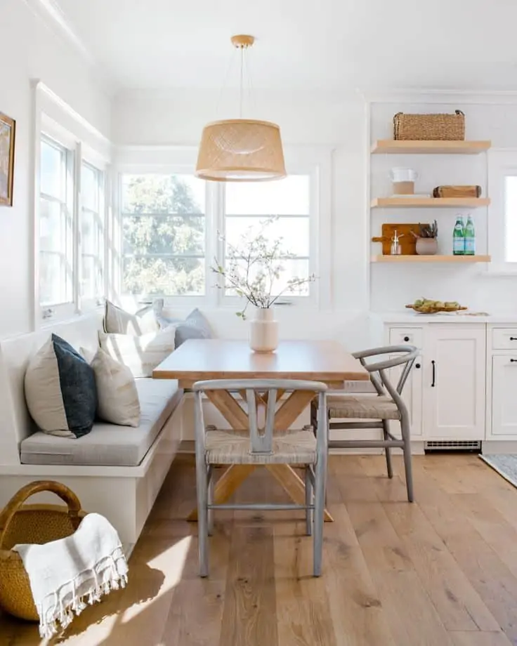 white kitchen nook natural wood table with light grey accents