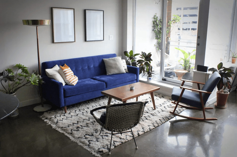 living room with royal blue sofa