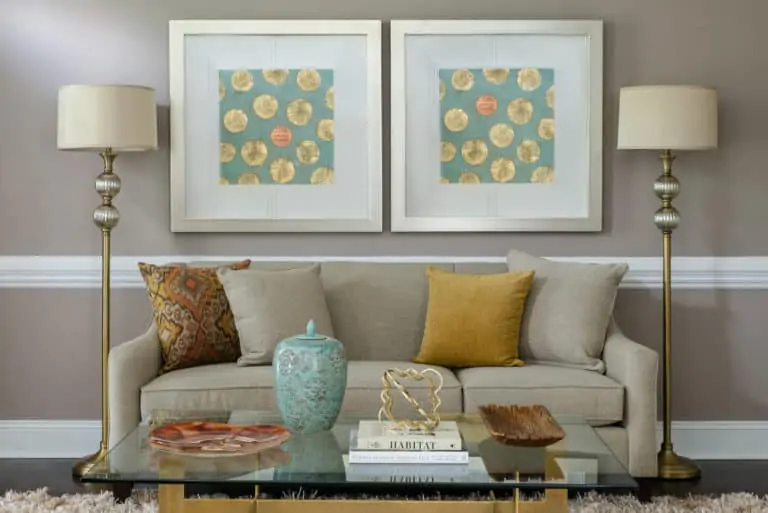 light brown sofa in living room with statement wall art and standing lamps