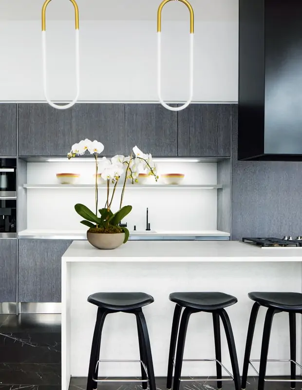 kitchen with black cabinets and barstools